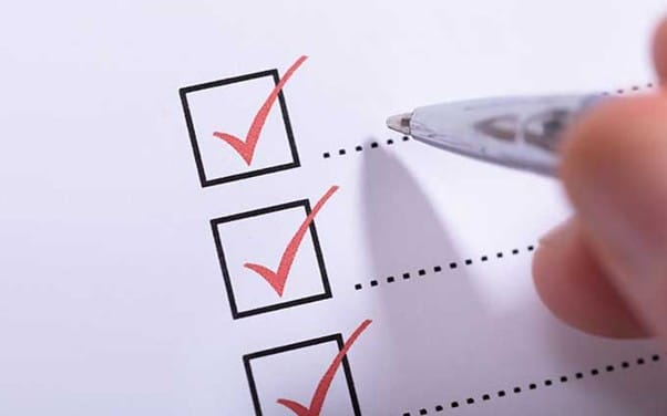 Person filling in details on paper Person filling in details on paper